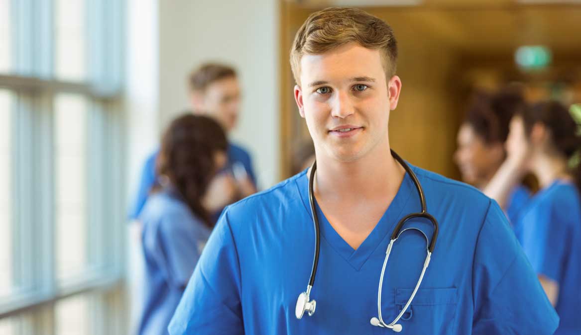 247 nursing & medical services, overseas nurse placements, nursing agency, young male nurse with colleagues in background