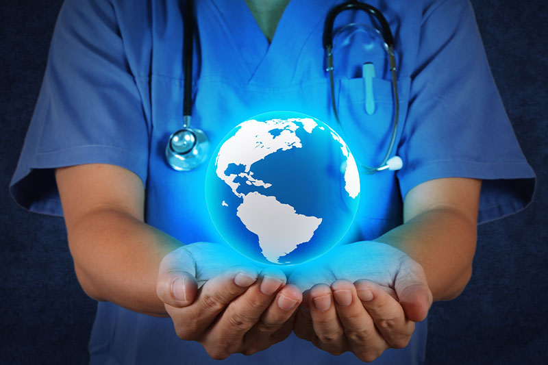 Global Nursing Workforce Disparities. Nurse holding globe in hand