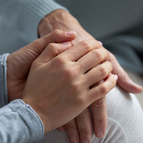 Carer holding hand of patient, compassionate care, 24/7 Nursing & Medical Services
