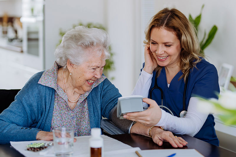 Registered nurse supporting elderly woman at home in Sydney, homecare, 247 Nursing + Medical Services.