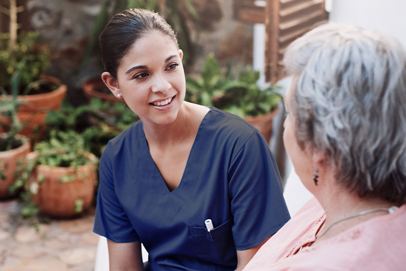 Nurse speaking with client showing respect for cultural and religious preferences in care
